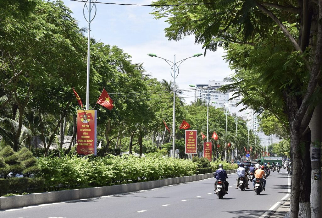 Xe máy lưu thông trên đại lộ rợp bóng cây ở Nha Trang